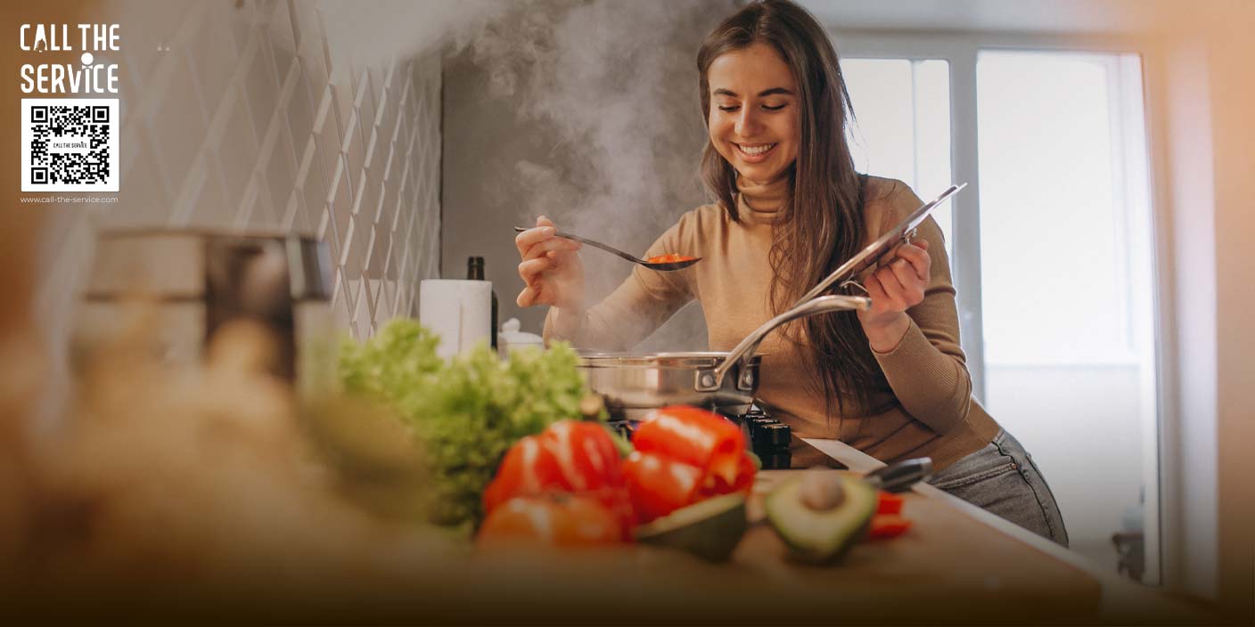 A woman doing sustainable cooking in her zero waste kitchen. She is using sustainable ingredients to reduce climate change